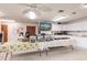 Bright kitchen featuring white cabinets and stainless steel buffet serving setup with floral tablecloth at 175 Kings Hwy # 538, Punta Gorda, FL 33983
