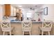 Eat-in kitchen boasting a breakfast bar with white stools and modern appliances at 175 Kings Hwy # 538, Punta Gorda, FL 33983
