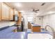 Well-lit kitchen showcasing blue countertops, an island, and wood cabinets at 175 Kings Hwy # 538, Punta Gorda, FL 33983