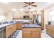 Bright kitchen features wood cabinets, stainless appliances, and center island with blue countertops at 175 Kings Hwy # 538, Punta Gorda, FL 33983