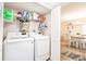 Laundry room features modern washer and dryer with shelf storage and an adjacent dining room at 175 Kings Hwy # 538, Punta Gorda, FL 33983