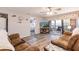 Bright living room offering wood-look floors and balcony access to outdoor seating at 175 Kings Hwy # 538, Punta Gorda, FL 33983