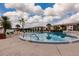 Community pool featuring blue water, palm trees, and plenty of lounge chairs at 175 Kings Hwy # 538, Punta Gorda, FL 33983