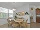 Light-filled dining room featuring a neutral color scheme and a direct view into the kitchen at 1805 Knights Bridge Trl, Port Charlotte, FL 33980