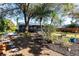 Landscaped backyard featuring a garden, stone path, and screened-in porch, perfect for outdoor relaxation and entertaining at 18379 Meyer Ave, Port Charlotte, FL 33948