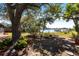 The backyard provides peaceful water views with lush landscaping, a boat dock, and a charming stone pathway at 18379 Meyer Ave, Port Charlotte, FL 33948