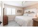Comfortable bedroom with light and airy design, wooden dresser, and white shutters at 18379 Meyer Ave, Port Charlotte, FL 33948