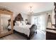Primary bedroom with decorative wall, chandelier and french doors to the outside at 18379 Meyer Ave, Port Charlotte, FL 33948