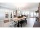 Elegant dining room features a farmhouse table with chandelier and view to kitchen at 18379 Meyer Ave, Port Charlotte, FL 33948