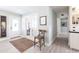 Bright entryway with light wood floors, white trim, a decorative rug, and stylish french doors at 18379 Meyer Ave, Port Charlotte, FL 33948