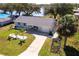 Charming single-story home with well-manicured lawn, concrete driveway, and mature trees near the water at 18379 Meyer Ave, Port Charlotte, FL 33948