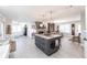 Open-concept living area with kitchen island, dining table, fireplace, and modern decor at 18379 Meyer Ave, Port Charlotte, FL 33948