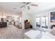 Living room featuring a white sofa, decorative ceiling fan, and access to the outdoors at 18379 Meyer Ave, Port Charlotte, FL 33948