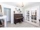 Cozy living room with piano and french doors leading to the dining area at 18379 Meyer Ave, Port Charlotte, FL 33948