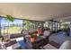 Relaxing outdoor patio offers comfortable seating, a fire pit, and views of the lush, green backyard and waterfront at 18379 Meyer Ave, Port Charlotte, FL 33948
