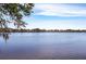 Beautiful waterfront view showcasing the serene lake and distant shoreline at 18379 Meyer Ave, Port Charlotte, FL 33948