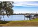 Picturesque waterfront view with a boat on a lift, serene water, and clear skies providing relaxation and recreational opportunities at 18379 Meyer Ave, Port Charlotte, FL 33948