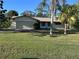 Charming single-story home features a well-maintained lawn and attached garage in a serene setting at 20262 Hamilton Ave, Port Charlotte, FL 33952