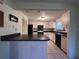 Open kitchen with a breakfast bar, black appliances, and abundant cabinet space at 20262 Hamilton Ave, Port Charlotte, FL 33952