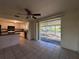 Open living space with sliding glass doors to the patio and views into the functional kitchen at 20262 Hamilton Ave, Port Charlotte, FL 33952