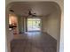 Bright living room with sliding doors leading to an outdoor patio and an attached kitchen at 20262 Hamilton Ave, Port Charlotte, FL 33952
