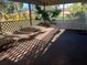 View of a covered and screened patio area featuring a small palm tree in the corner at 20262 Hamilton Ave, Port Charlotte, FL 33952