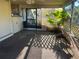 View of a covered and screened patio area featuring a small palm tree and lattice screen at 20262 Hamilton Ave, Port Charlotte, FL 33952