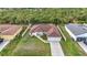 Aerial view of a well-maintained house, complete with a pristine lawn, and a two-car garage at 2051 Snover Ave, North Port, FL 34286