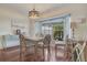 Bright dining room with a bay window, modern light fixture, and seating for four at 2051 Snover Ave, North Port, FL 34286