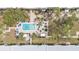 Aerial view of a community featuring a sparkling pool surrounded by lush landscaping at 21287 Gertrude Ave # 106, Port Charlotte, FL 33952