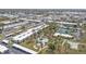 Aerial view of condo community with a pool, tennis courts, and lush landscaping at 21287 Gertrude Ave # 106, Port Charlotte, FL 33952