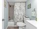 Charming bathroom with floral curtain, ceramic tiles and modern fixtures at 21287 Gertrude Ave # 106, Port Charlotte, FL 33952