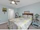 The stylish bedroom features a ceiling fan, tiled floors, and a comfy bed at 21287 Gertrude Ave # 106, Port Charlotte, FL 33952
