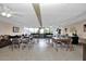 A spacious community clubhouse featuring tables, chairs, and comfortable seating areas at 21287 Gertrude Ave # 106, Port Charlotte, FL 33952