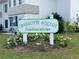 Entrance to Charlotte Square Condominiums with well-maintained landscaping and signage at 21287 Gertrude Ave # 106, Port Charlotte, FL 33952