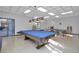 Bright game room featuring a pool table, ping pong table, and bench seating for relaxation and entertainment at 21287 Gertrude Ave # 106, Port Charlotte, FL 33952