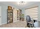 Bright home office features built-in shelving, stylish decor, and a comfortable seating area at 21287 Gertrude Ave # 106, Port Charlotte, FL 33952