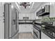 Modern kitchen with white cabinetry, stainless steel appliances, and updated countertops at 21287 Gertrude Ave # 106, Port Charlotte, FL 33952