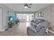 Inviting living room with tile flooring, white brick accent wall, and comfortable seating at 21287 Gertrude Ave # 106, Port Charlotte, FL 33952