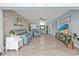Bright living room featuring tile flooring, a stylish accent wall, and comfortable seating at 21287 Gertrude Ave # 106, Port Charlotte, FL 33952