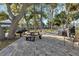 A community outdoor patio with picnic tables, and BBQ grills in a park-like setting at 21287 Gertrude Ave # 106, Port Charlotte, FL 33952