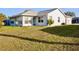Backyard featuring lush grass, an AC unit, and an exterior view of the home at 21332 Walling Ct, Port Charlotte, FL 33954