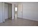 Neutral bedroom showcasing tile floors, an open closet, and an adjacent room at 21332 Walling Ct, Port Charlotte, FL 33954