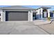 Charming home featuring a gray garage door, walkway, and a well-maintained lawn at 21332 Walling Ct, Port Charlotte, FL 33954