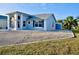 The house boasts neutral paint, modern windows, decorative shutters, and low-maintenance gravel landscaping at 21332 Walling Ct, Port Charlotte, FL 33954