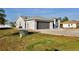Charming home featuring a gray garage door, driveway, and a well-maintained lawn at 21332 Walling Ct, Port Charlotte, FL 33954
