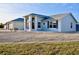 The home showcases a decorative front door, neutral paint, modern windows, and a gravel yard at 21332 Walling Ct, Port Charlotte, FL 33954