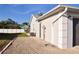View of the side of the house with lush grass, rocks, and an AC unit in the backyard at 21332 Walling Ct, Port Charlotte, FL 33954