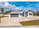 Front exterior view of a well-maintained, light-colored home with an attached garage and inviting entrance at 21332 Walling Ct, Port Charlotte, FL 33954
