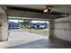 View from inside a clean garage out to the street with neighboring houses and parked cars at 21332 Walling Ct, Port Charlotte, FL 33954